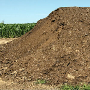 pile of poultry litter in a farmer's field